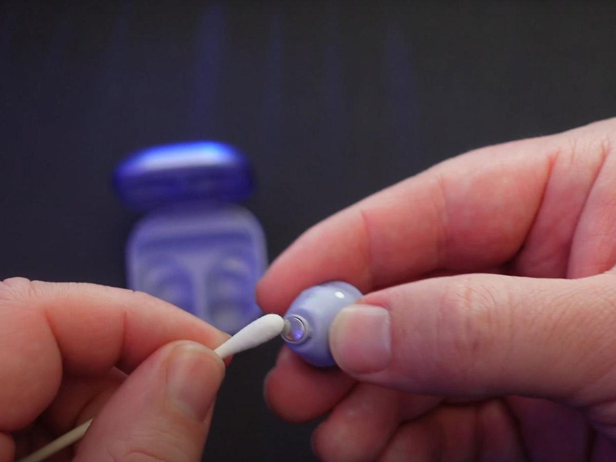 Clean the ear tips and earbuds with the damp cotton swab. (From: Youtube/ GregglesTV)